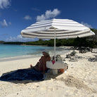 Swimbrella converting from floating pool umbrella to beach umbrella table